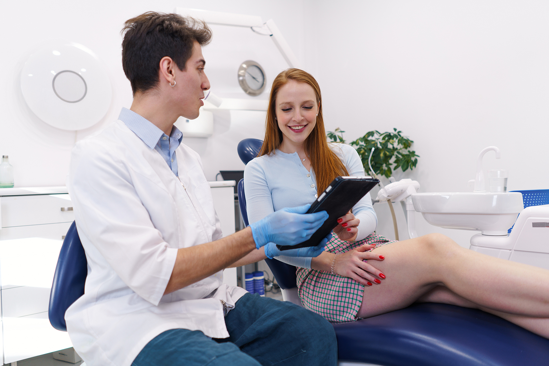 dentist showing treatment options to happy woman 2022 01 20 19 48 08 utc